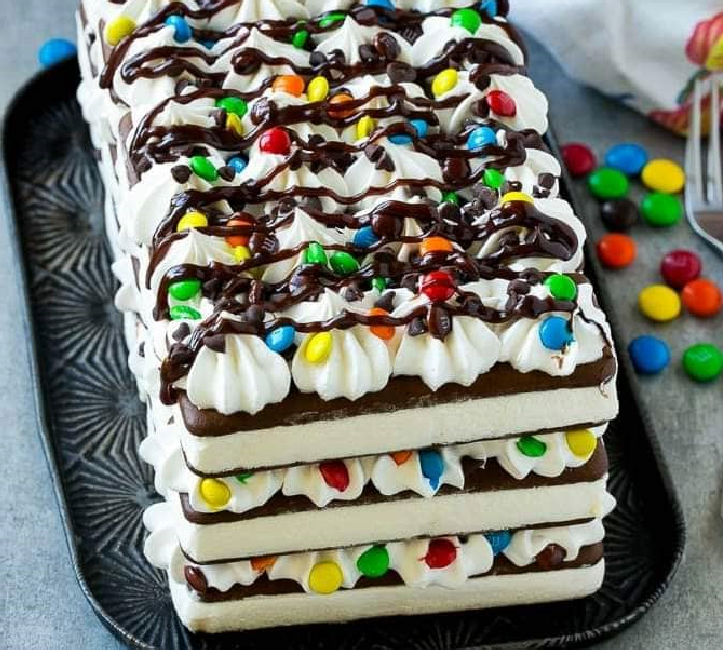Ice Cream Sandwich Cake  This ice cream sandwich cake is layers of ice cream sandwiches, whipped topping and candy, all stacked up to form an easy yet super impressive dessert. An ice cream sandwich cake is perfect for summer gatherings, birthday parties and school events!