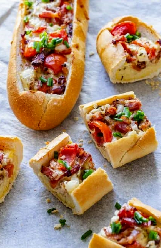 stuffed baguette is filled with a delicious mixture of eggs, bacon, onion, cheese and tomatoes.